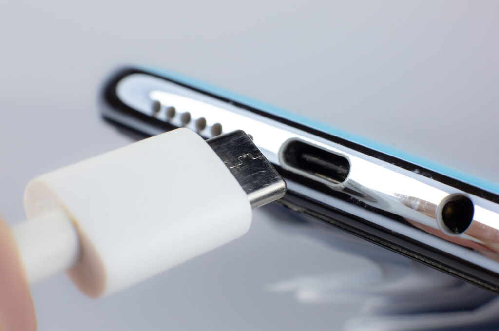 man connecting usb type c port cable charging smartphone close up photo
