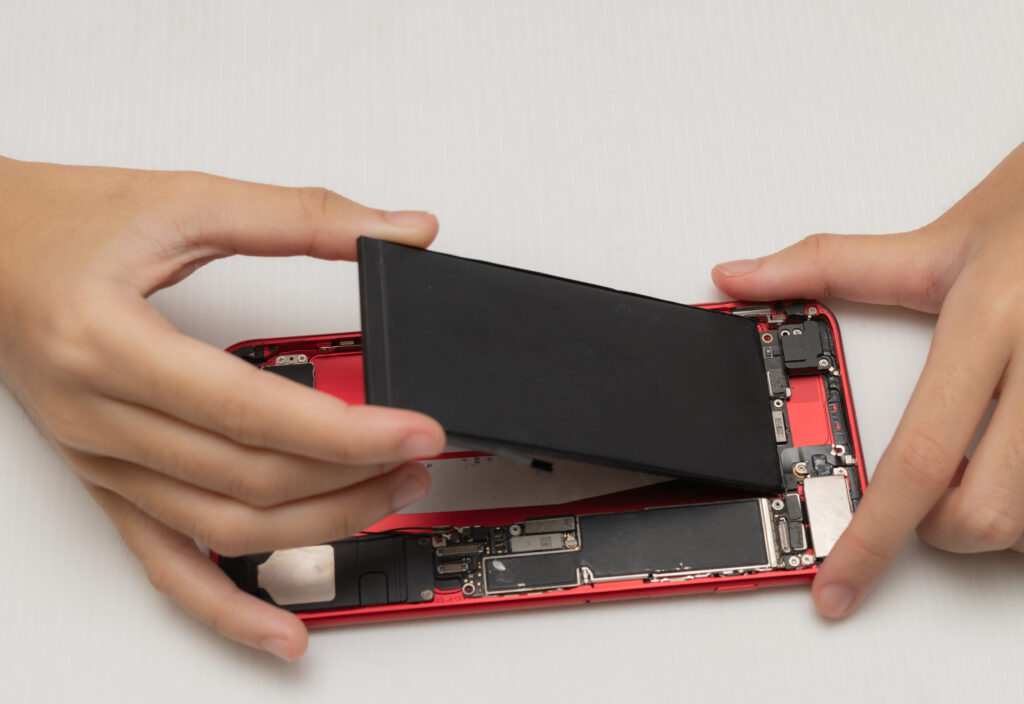technician replaces battery cell phone smartphone